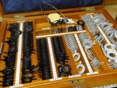 A cased set of opticians eye testing lenses