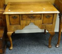 An antique nineteenth century walnut low boy having three drawers with inlay and on cabriole