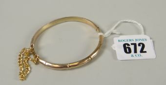 A 9ct yellow gold 'bamboo' bangle with safety chain, 8.2grams Please note: not tested, hallmarks,