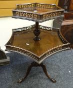 A good antique galleried tripod mahogany dumbwaiter having two shaped graduated tiers on carved