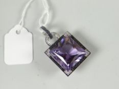 A modern 18ct yellow gold and white metal purple gemstone, possibly amethyst, and tiny diamond