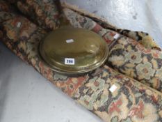 A vintage Persian carpet and a brass turned handle warming pan