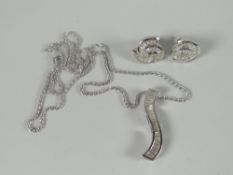 A modern set of 18ct white gold pendant and matching stud-earrings, each set with multiple