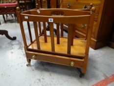 A reproduction yew wood two-section canterbury with single drawer base