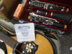 A cased clarinet together and cased mandolin