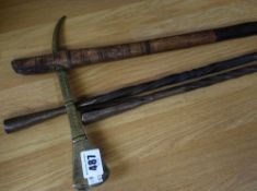 A pair of early twentieth century metal spear heads together with an early twentieth century brass