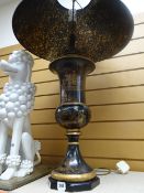 An ebonized and gilt decorated Chinese table lamp and shade by Theodore Alexander