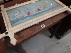 A vintage sloping school desk with lift up lid and a vintage picture of a steam ship