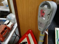 A mid-century Wandsworth Burrough Council parking meter and three warning signs for Flood and Trains