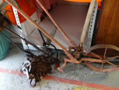 A parcel of vintage farm implements including plough, scythe, an old anchor, pullies and chains ETC