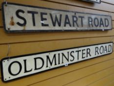A street sign for Old Minster Road and Stewart Road