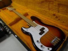 A cased Hudson Guitar Company electric base four-string guitar