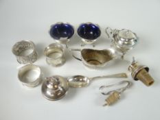 A parcel of small silver items including a cork and silver wine spout, a silver stopper with leaping