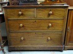 A Victorian mahogany chest of two long and two short drawers having turned handles and a pair of