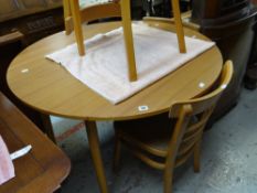 A mid-century circular kitchen table and four chairs