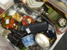 Two tins of collectables including military-type badges, miniature binoculars, trinkets ETC