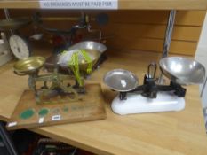 A set of vintage brass scales on a wooden stand with provision for weights, the brass mount