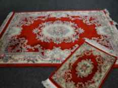 Red ground Chinese-style wash rug and similar runner, 255 x 168cms & 95 x 60cms (2)