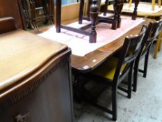 A vintage extending draw leaf dining table and four chairs and with similar period oak sideboard