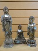 Three similar metallic buddha figures in various poses, the tallest being 37cms high