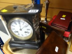 A black marble mantel clock with circular Roman numeral face, pair of EPNS candlesticks, wallets