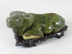 A modern sculptured jade figure of a cow with stand (boxed)