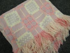 A pink and cream geometric patterned Welsh blanket