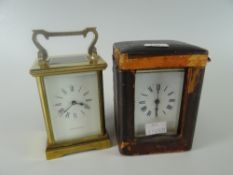 A vintage brass encased French carriage clock with outer fitted case and another later carriage