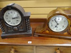 An inlaid mahogany mantel clock with circular dial and Arabic numerals and another barley-twist