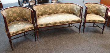 An antique / vintage three-piece floral upholstered antique tub-style suite comprising two armchairs