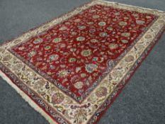 A good large rust ground floral Persian carpet, 340 x 235cms
