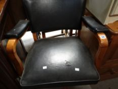 A mid-century lightwood and leather upholstered swivel armchair