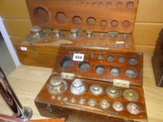 A vintage cased set of brass weights and another