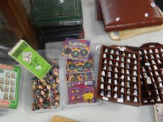 Collection of souvenir pottery thimbles, case of Panini-type football stickers and Pokemon