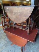 A reproduction drop flap dining table in cherry with drawer and a vintage gateleg table