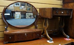 An antique mahogany bow front toilet mirror having three drawers together with a small