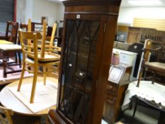A reproduction mahogany astragal glazed top corner cabinet with a cupboard base together with a
