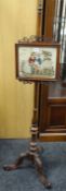 A Victorian pole screen with Berlin woolwork panel