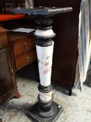 An early twentieth century ebonized and flower decorated jardiniere stand, 110cms tall