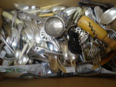 A box of various loose flatware