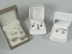 Four pairs of modern earrings including 18ct white gold and sapphire drop earrings, similar