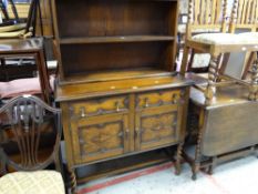 A vintage stained oak dresser having a cupboard base and open shelf top, 101cms wide