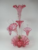 An excellent Victorian cranberry and clear glass epergne, the dished base of circular form with