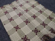 A pale green and plum geometric Welsh blanket