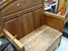 A vintage rustic lightwood panel settle