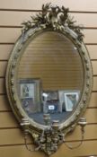 A good antique gilt framed mirror with moulded decoration, cherubic and laurel finial and three-