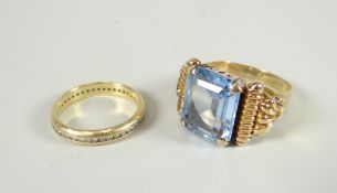 A modern 18ct yellow gold ring set with blue gemstone possibly tourmaline and having raised carved