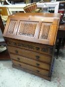 An oak Old Charm drop down bureau with a four-drawer base
