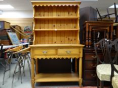 A modern pine dresser with two drawers and lower shelf and open rack, 101cms wide and a nest of