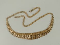 A modern yellow gold necklace having a graduated centrepiece, marked 375, 11gms Please note: not